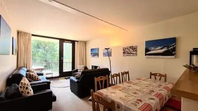 a living room with a couch and a table at Résidence Belier - Appartement confortable et spacieux · Au pied des pistes · WIFI gratuit et illimité MAE-8211 in Magland