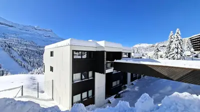 a building in the snow with snow around it at Résidence Belier - Appartement confortable et spacieux · Au pied des pistes · WIFI gratuit et illimité MAE-8211 in Magland