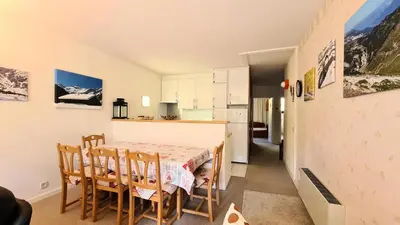 a kitchen and dining room with a table and chairs at Résidence Belier - Appartement confortable et spacieux · Au pied des pistes · WIFI gratuit et illimité MAE-8211 in Magland