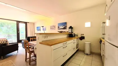 a kitchen with a counter top and a refrigerator at Résidence Belier - Appartement confortable et spacieux · Au pied des pistes · WIFI gratuit et illimité MAE-8211 in Magland