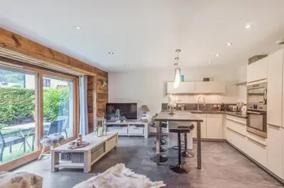 a kitchen with a table and a large window at Villa Princesse - Centre-ville - Renove in Chamonix-Mont-Blanc