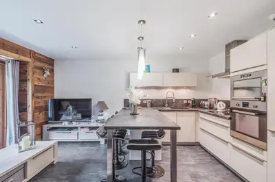 a kitchen with a table and chairs in it at Villa Princesse - Centre-ville - Renove in Chamonix-Mont-Blanc