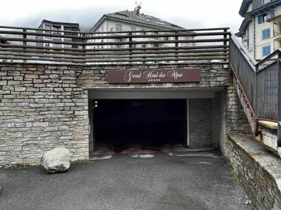 a brick garage with a sign on top of it at Chamonix centre, « Lucille »,balcon, vue imprenable et parking in Chamonix-Mont-Blanc
