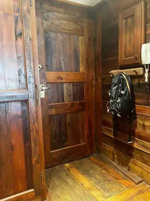 a wooden room with a door and a backpack on the wall at Chamonix centre, « Lucille »,balcon, vue imprenable et parking in Chamonix-Mont-Blanc