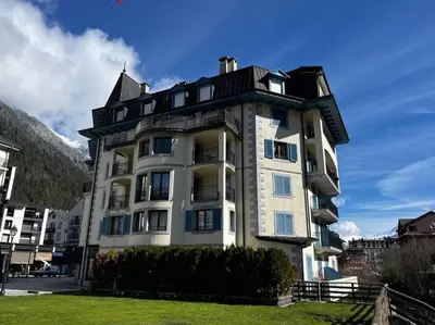 a large white building with a black roof at Chamonix centre, « Lucille »,balcon, vue imprenable et parking in Chamonix-Mont-Blanc