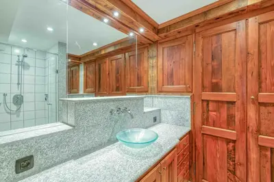 a bathroom with a sink and a glass shower at Chamonix centre, « Lucille »,balcon, vue imprenable et parking in Chamonix-Mont-Blanc