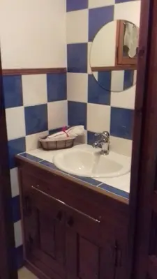 a bathroom with a sink and a mirror at Chalet Indépendant 