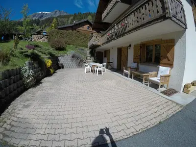 a patio with a table and chairs outside of a building at Studio 