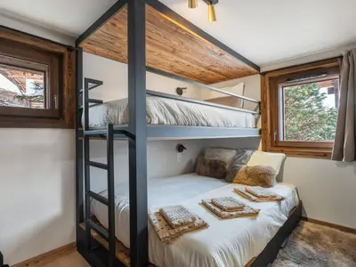 a bedroom with bunk beds in a tiny house at Chalet avec spa partagé, 5 chambres, piscine, parkings à Megève - FR-1-569-187 in Megève