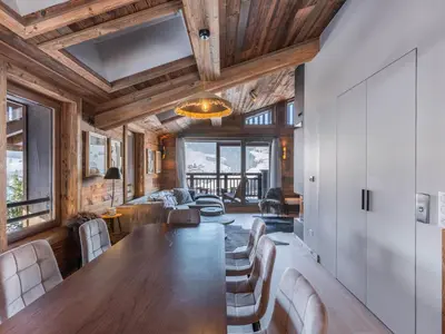 a dining room with a long table and chairs at Chalet avec spa partagé, 5 chambres, piscine, parkings à Megève - FR-1-569-187 in Megève