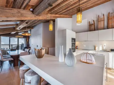 a kitchen with white cabinets and a table with vases on it at Chalet avec spa partagé, 5 chambres, piscine, parkings à Megève - FR-1-569-187 in Megève