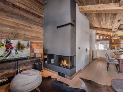 a living room with a tv and a fireplace at Chalet avec spa partagé, 5 chambres, piscine, parkings à Megève - FR-1-569-187 in Megève