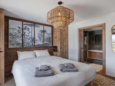 a bedroom with a bed with towels on it at Appartement neuf avec espace bien-être, sauna et hammam - FR-1-569-188 in Megève
