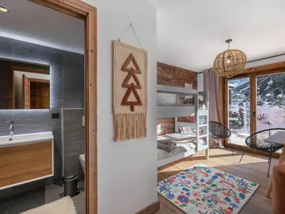 a room with a bedroom and a bunk bed at Appartement neuf avec espace bien-être, sauna et hammam - FR-1-569-188 in Megève