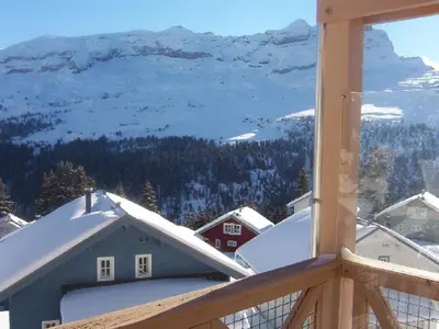 a view of a snow covered mountain from a balcony at Appartement confortable 2 chambres, balcon sud, 6 pers. - FR-1-425-213 in Arâches-la-Frasse