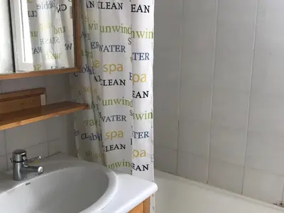 a bathroom with a sink and a shower curtain at Appartement confortable 2 chambres, balcon sud, 6 pers. - FR-1-425-213 in Arâches-la-Frasse