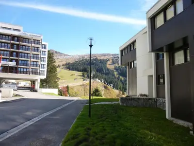 an empty street next to a building with a street light at Appartement rénové au pied des pistes avec balcon - FR-1-425-215 in Arâches-la-Frasse
