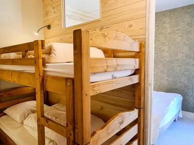 a couple of bunk beds in a room at Appartement rénové au pied des pistes avec balcon - FR-1-425-215 in Arâches-la-Frasse