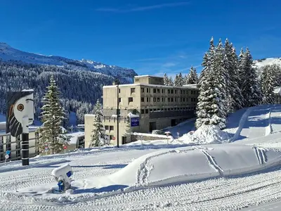 a snow covered mountain with a building in the background at Appartement lumineux, pied des pistes - 6 pers. - FR-1-425-222 in Arâches-la-Frasse