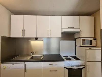a kitchen with white cabinets and a sink and appliances at Appartement lumineux, pied des pistes - 6 pers. - FR-1-425-222 in Arâches-la-Frasse