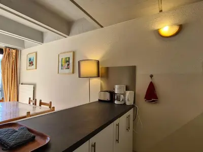a kitchen with a counter top and a table at Appartement lumineux, pied des pistes - 6 pers. - FR-1-425-222 in Arâches-la-Frasse