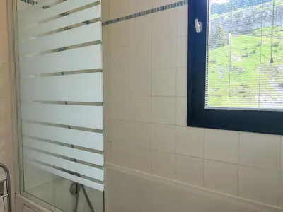 a bathroom with a shower and a window at Studio lumineux balcon ski aux pieds - 4 pers. - FR-1-425-223 in Arâches-la-Frasse
