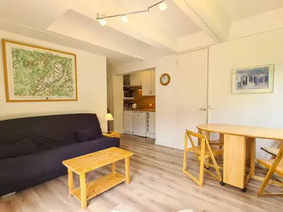 a living room with a couch and a table at Studio lumineux balcon ski aux pieds - 4 pers. - FR-1-425-223 in Arâches-la-Frasse