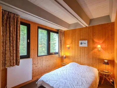 a bedroom with a bed and two windows at Appartement spacieux, balcon - 8 pers. - FR-1-425-218 in Arâches-la-Frasse