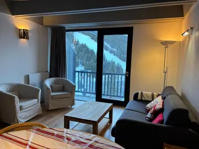 a living room with a couch and a large window at Appartement spacieux, balcon - 8 pers. - FR-1-425-218 in Arâches-la-Frasse