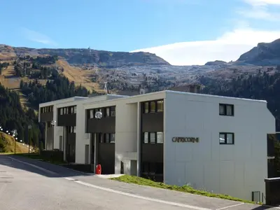 a view of a building with a mountain in the background at Appartement rénové 6 pers, balcon, au pied des pistes - FR-1-425-221 in Arâches-la-Frasse