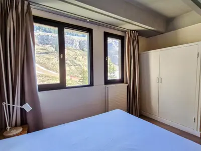 a bedroom with a bed and two windows at Appartement spacieux, balcon, skis aux pieds - 8 pers. - FR-1-425-216 in Arâches-la-Frasse