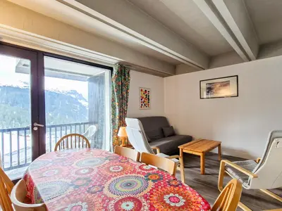 a room with a table and chairs and a window at Appartement spacieux balcon sud - 6 pers. - FR-1-425-219 in Arâches-la-Frasse