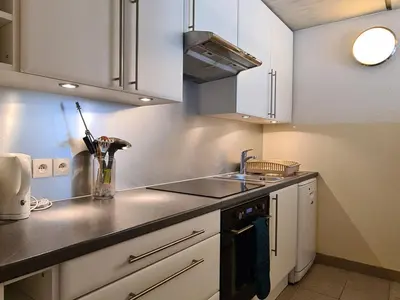 a kitchen with white cabinets and a sink at Appartement spacieux balcon sud - 6 pers. - FR-1-425-219 in Arâches-la-Frasse