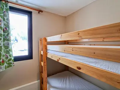 a bedroom with two bunk beds and a window at Studio confortable au pied des pistes - 4 pers. - FR-1-425-224 in Arâches-la-Frasse