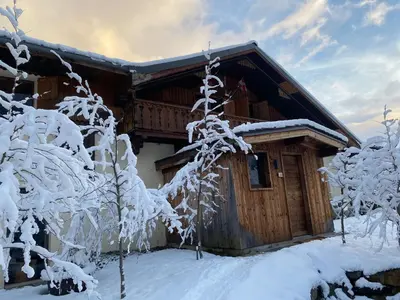a cabin with snow covered trees in front of it at Joyeux Flocon - Spacieux chalet in Les Contamines-Montjoie