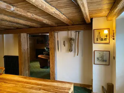 a room with wooden ceilings and a wall with guns at Joyeux Flocon - Spacieux chalet in Les Contamines-Montjoie
