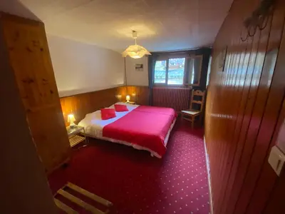 a bedroom with a bed with a red blanket at Joyeux Flocon - Spacieux chalet in Les Contamines-Montjoie