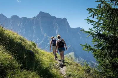 two people walking down a mountain trail at Samoëns, new apartment, 3 bedrooms, 6 persons, close to village centre and skibus in Samoëns