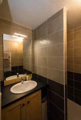 a bathroom with a sink and a mirror at Samoëns, new apartment, 3 bedrooms, 6 persons, close to village centre and skibus in Samoëns