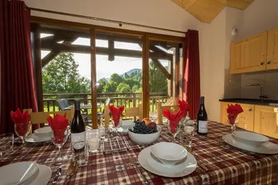 a table with wine glasses and a bowl of grapes at Samoëns, new apartment, 3 bedrooms, 6 persons, close to village centre and skibus in Samoëns