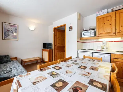 a kitchen and a table in a room at Les Eterlous 25 - Appt vue pistes 4 pers in Morillon