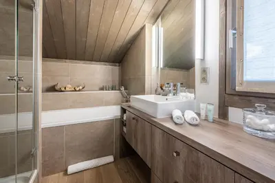 a bedroom with a bed with a large window at Chalet Satine - Luxe au pied des pistes in Demi-Quartier