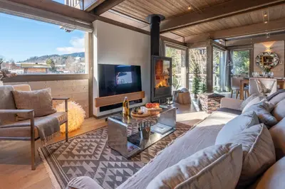 a kitchen with a table with utensils on it at Chalet Satine - Luxe au pied des pistes in Demi-Quartier