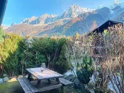a picnic table with a view of the mountains at Cosy Petite Chalet T3, Jardin, Terrasse, Parking. Chamonix Mont-blanc. in Les Houches