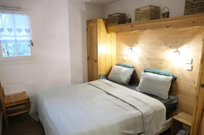 a bedroom with a large bed with a wooden headboard at Résidence Le Grand Panorama - Grand Panorama 214 MAE-7851 in Saint-Gervais-les-Bains