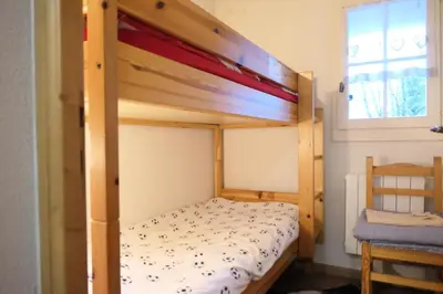 a wooden bunk bed in a room with a window at Résidence Le Grand Panorama - Grand Panorama 214 MAE-7851 in Saint-Gervais-les-Bains