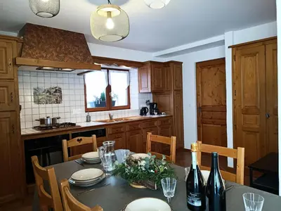 a kitchen with a table with chairs and a dining room at Résidence La Planchette - L'Alpin - 4 pièces dans un chalet individuel MAE-7861 in Saint-Gervais-les-Bains