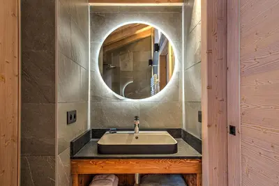 a bathroom with a sink and a mirror at Chalet Belle des Neiges - Alpes Travel - Sleeps 9 in Les Houches