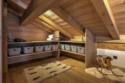 a room with wooden ceilings and shelves with pots at Chalet Belle des Neiges - Alpes Travel - Sleeps 9 in Les Houches