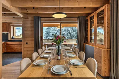 a dining room with a long table and chairs at Chalet Belle des Neiges - Alpes Travel - Sleeps 9 in Les Houches